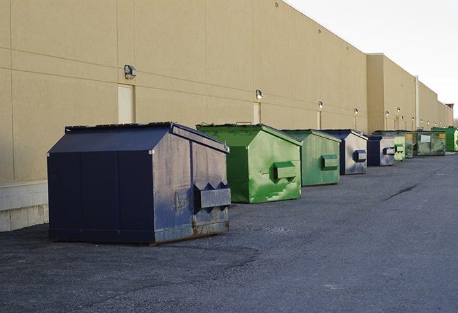 a yellow construction dumpster filled with waste materials in Bartlett, IL